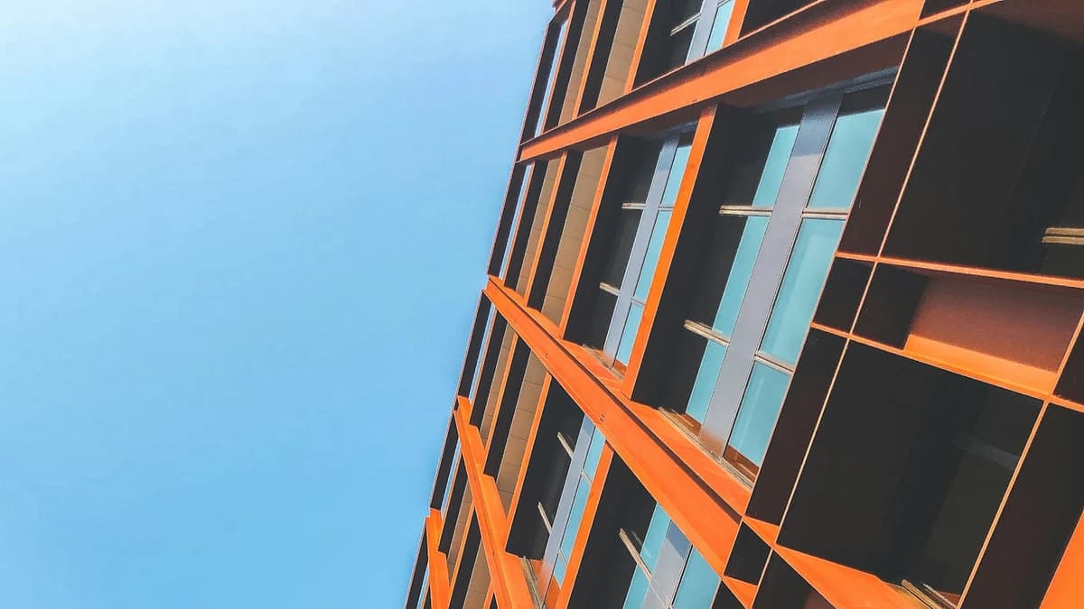 Modern orange facade representing the launch of Claude Opus 5